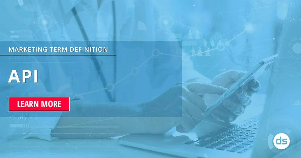 Person using a laptop and smartphone with a digital overlay featuring the text "API definition" and a "learn more" button.